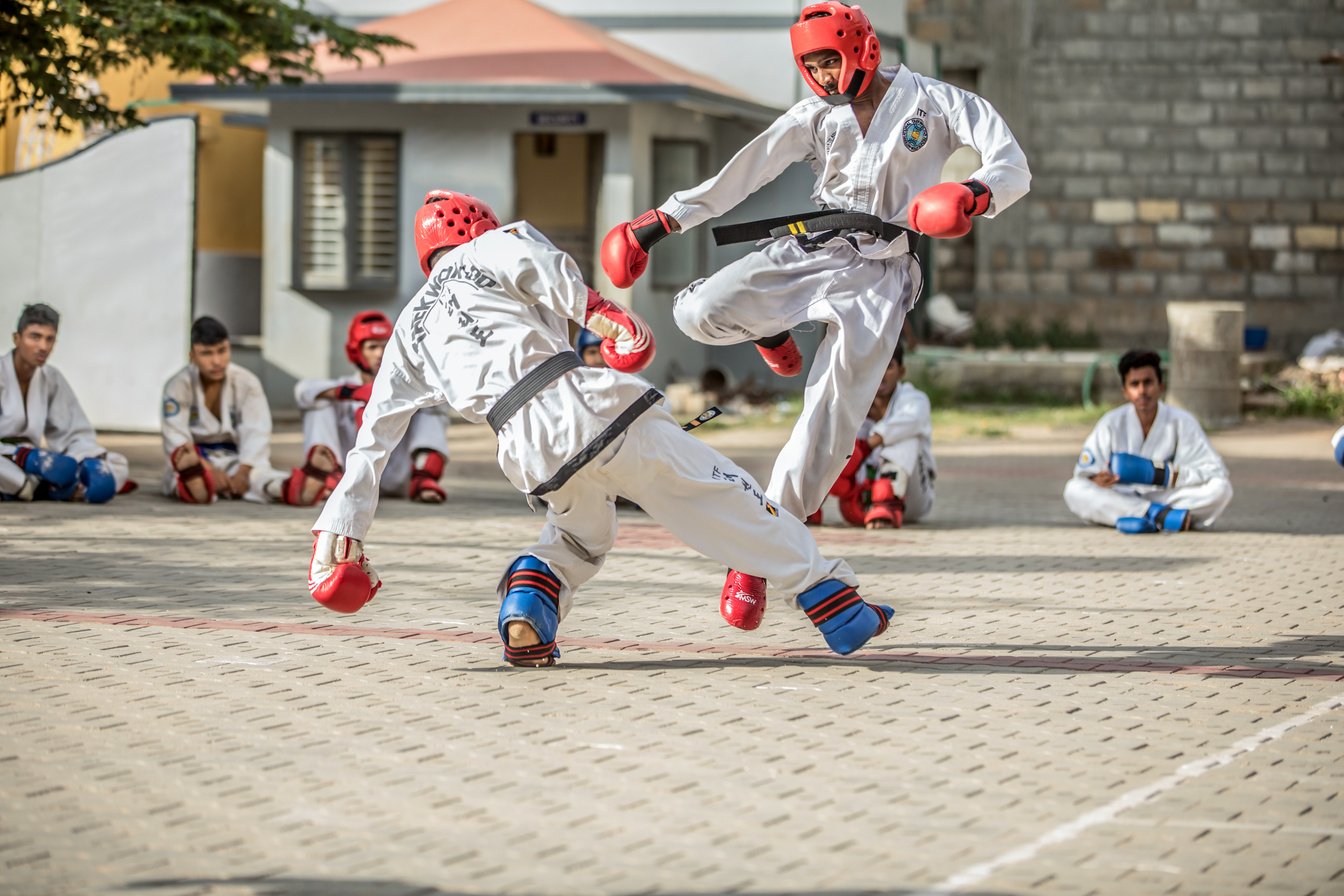 Taekwondo Practitioners in a Sparring Match